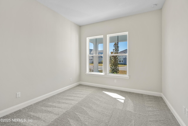 spare room featuring light colored carpet