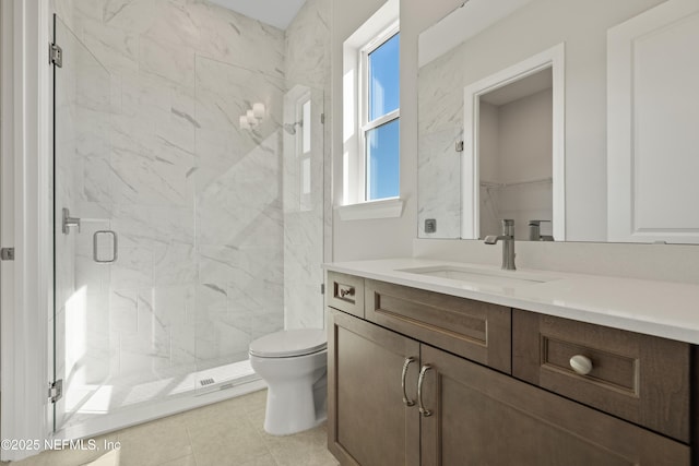 bathroom featuring toilet, vanity, tile patterned flooring, and walk in shower