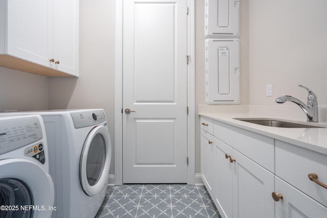 laundry area featuring independent washer and dryer, cabinets, and sink