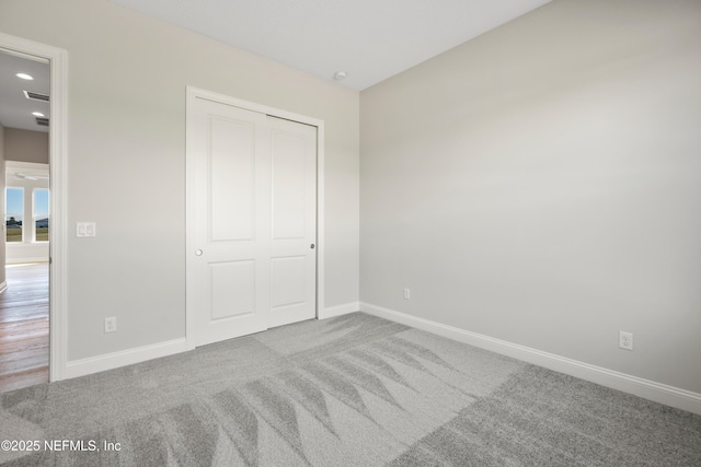 unfurnished bedroom featuring a closet and carpet