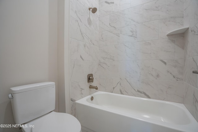 bathroom featuring toilet and tiled shower / bath combo