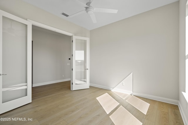 unfurnished bedroom with french doors, ceiling fan, and light wood-type flooring