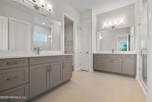 bathroom with vanity and a shower with shower door