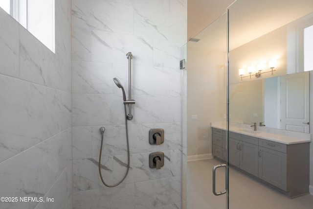 bathroom with vanity and a shower with shower door