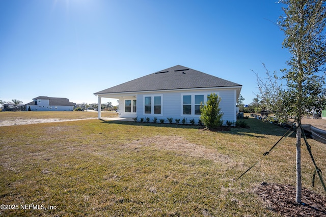 back of property featuring a yard