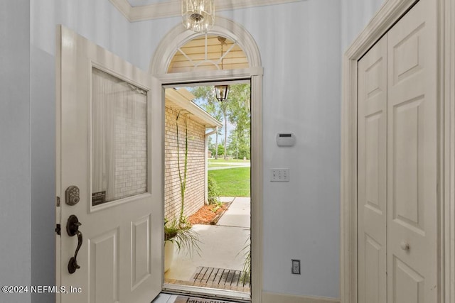 doorway featuring a notable chandelier