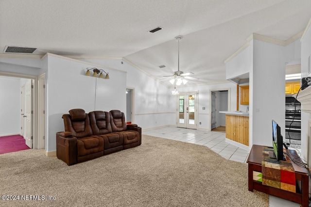 living room featuring crown molding, lofted ceiling, light carpet, and french doors