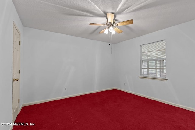 carpeted spare room with ceiling fan and a textured ceiling