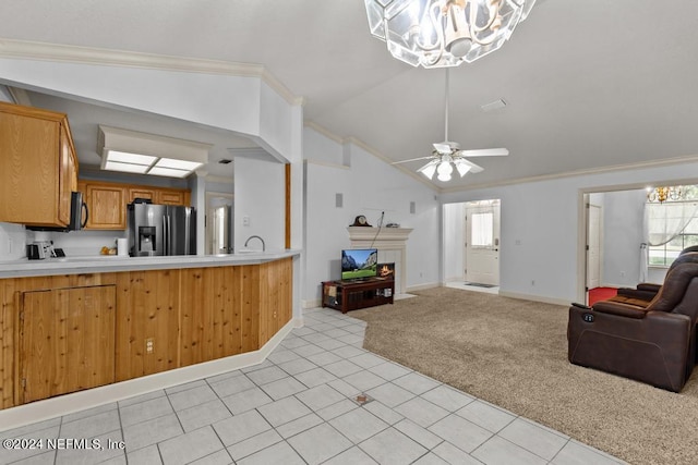 kitchen with ceiling fan with notable chandelier, lofted ceiling, stainless steel fridge, light colored carpet, and crown molding