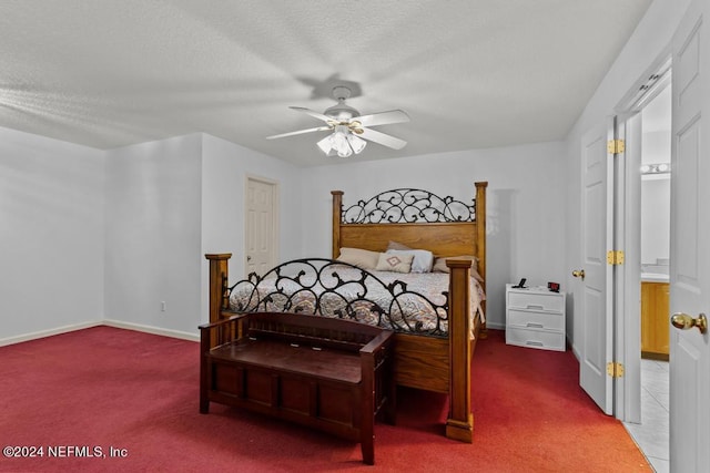 bedroom with ceiling fan, carpet floors, and a textured ceiling