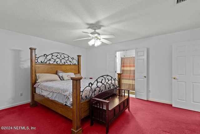 carpeted bedroom with ceiling fan and a textured ceiling