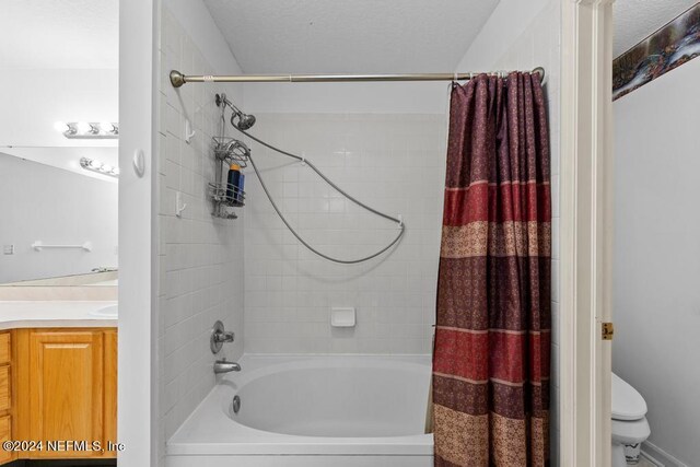 full bathroom featuring shower / bathtub combination with curtain, vanity, and toilet