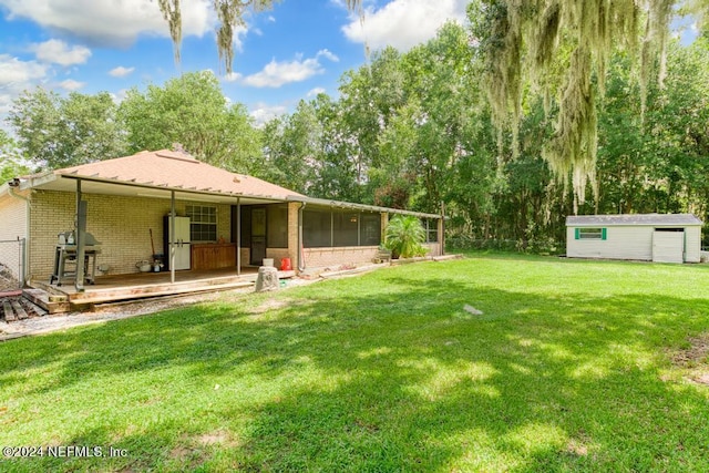 view of yard featuring a wooden deck and a storage unit