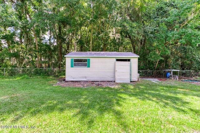 view of outbuilding featuring a lawn