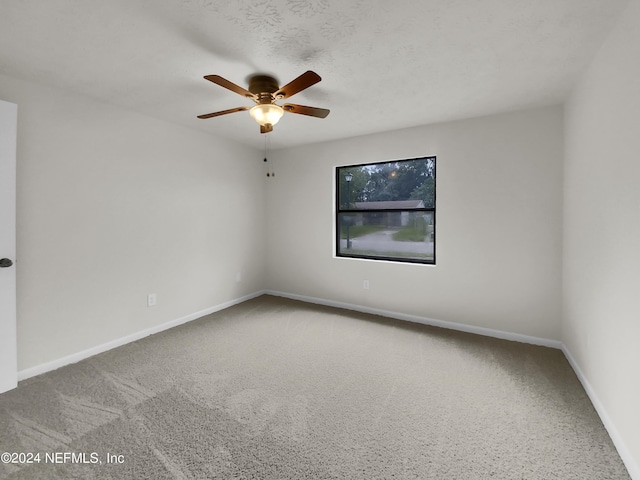 empty room with ceiling fan and carpet flooring