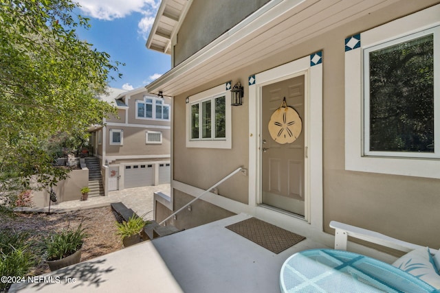 doorway to property with a garage