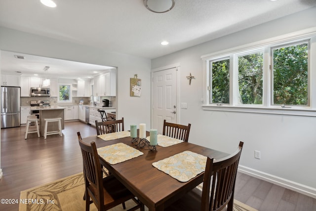 dining area with dark wood-type flooring