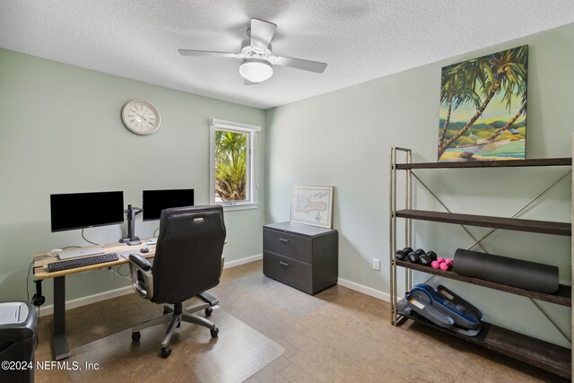 home office featuring ceiling fan and a textured ceiling