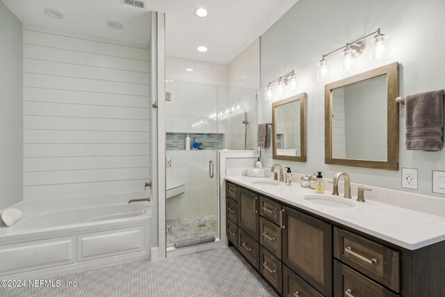 bathroom featuring tile patterned flooring, vanity, and plus walk in shower