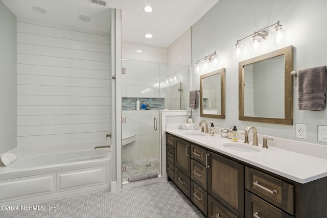 bathroom with plus walk in shower, tile patterned flooring, and vanity