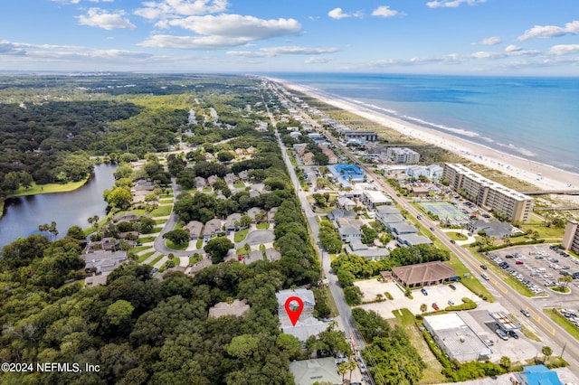 drone / aerial view featuring a water view and a view of the beach