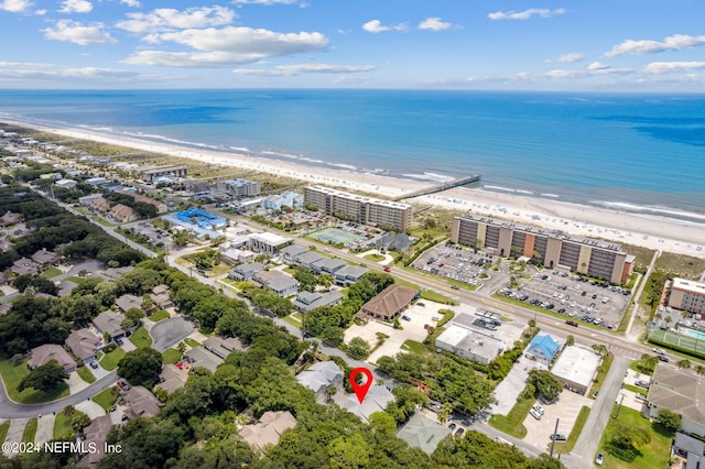 birds eye view of property featuring a water view and a beach view