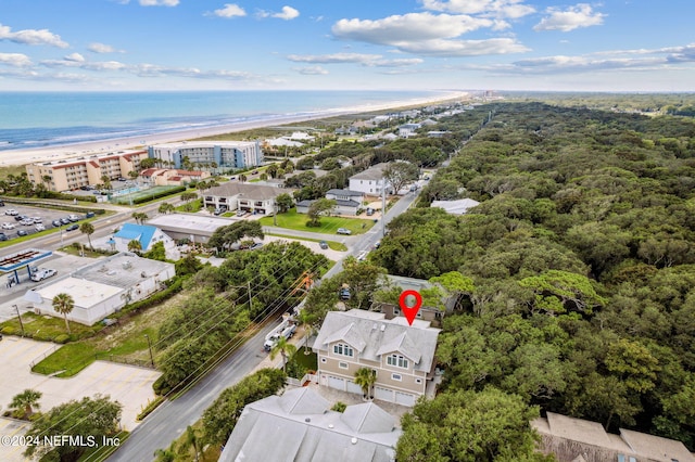 drone / aerial view featuring a beach view and a water view