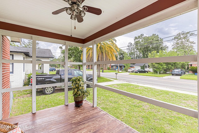 wooden deck featuring ceiling fan and a lawn