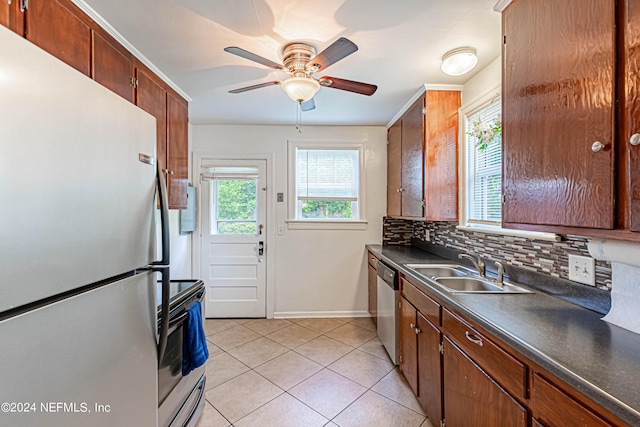 kitchen with stainless steel appliances, sink, decorative backsplash, light tile patterned flooring, and ceiling fan