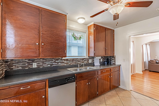 kitchen featuring stainless steel dishwasher, light wood-type flooring, ceiling fan, and backsplash