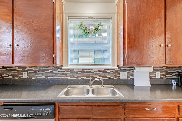 kitchen with plenty of natural light, backsplash, sink, and dishwasher