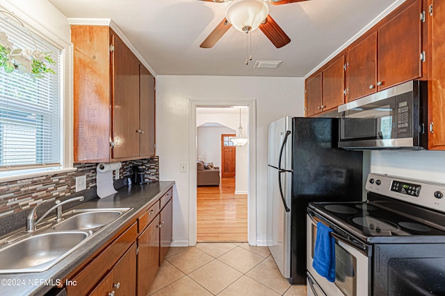 kitchen with stainless steel appliances, sink, backsplash, light tile patterned flooring, and ceiling fan