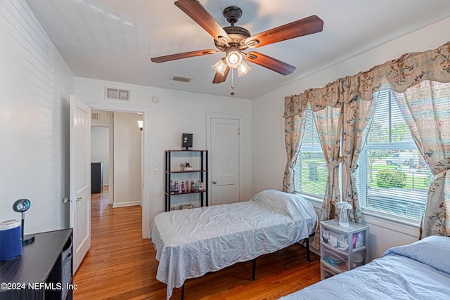 bedroom with ceiling fan and hardwood / wood-style floors