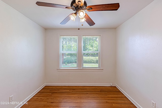 spare room featuring hardwood / wood-style floors and ceiling fan