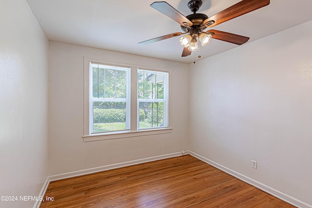 spare room featuring hardwood / wood-style flooring and ceiling fan