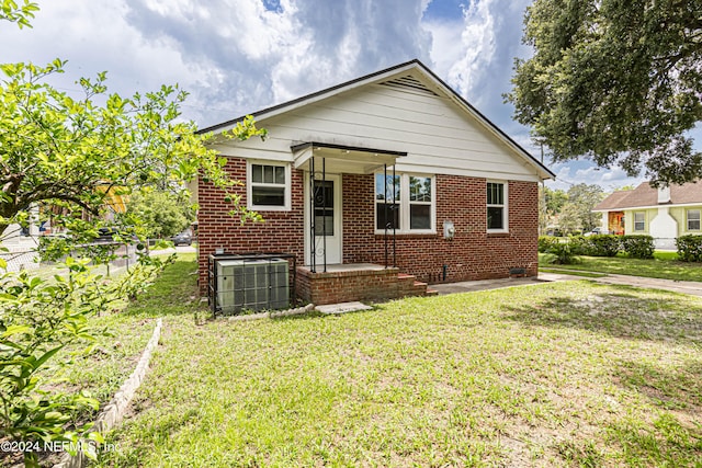 bungalow-style home featuring central AC and a front lawn