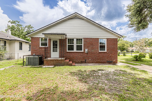 bungalow-style home with central AC and a front lawn