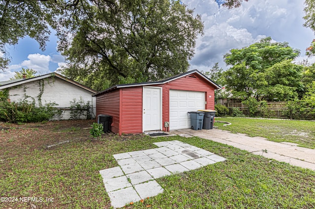 exterior space featuring a garage and a lawn