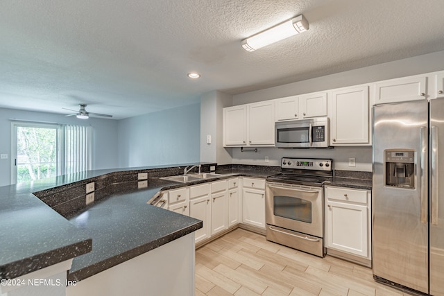 kitchen featuring white cabinets, stainless steel appliances, and ceiling fan