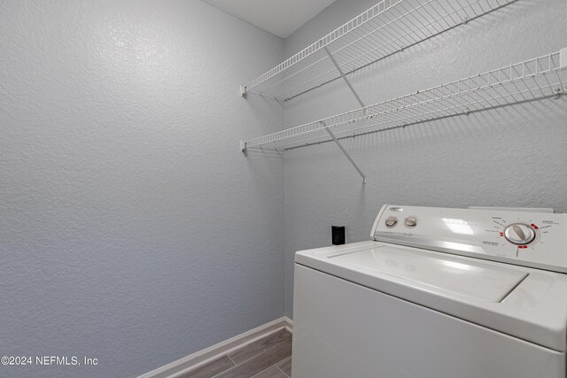 washroom featuring washer / clothes dryer and dark wood-type flooring