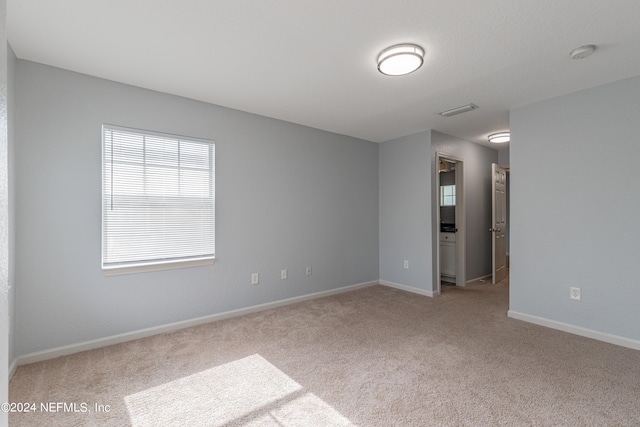 unfurnished bedroom featuring light colored carpet