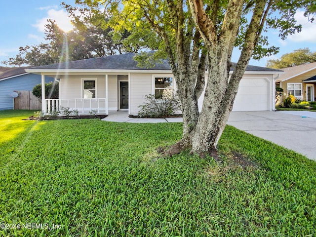 single story home featuring a garage, a front yard, and a porch