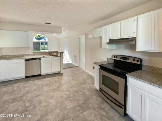 kitchen featuring white cabinetry, stainless steel appliances, light stone countertops, and a textured ceiling