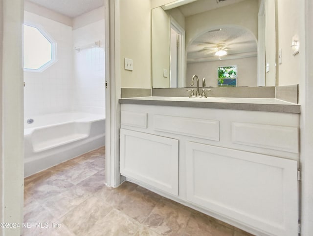 bathroom with vanity, a wealth of natural light, bathtub / shower combination, and ceiling fan