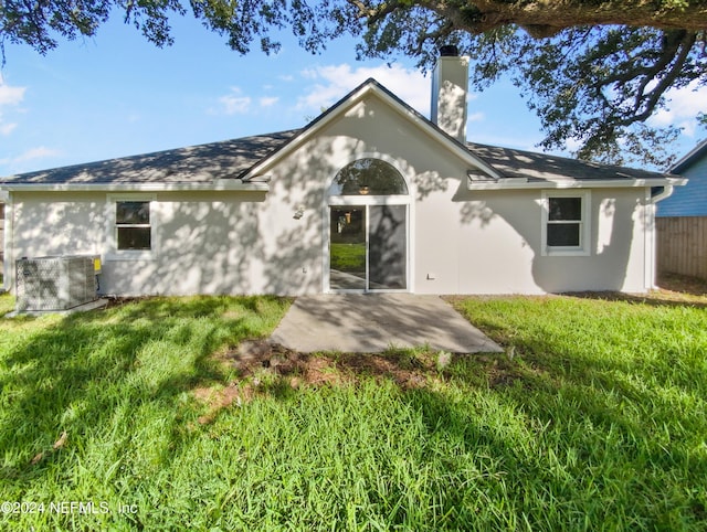 rear view of property with a patio area and a lawn