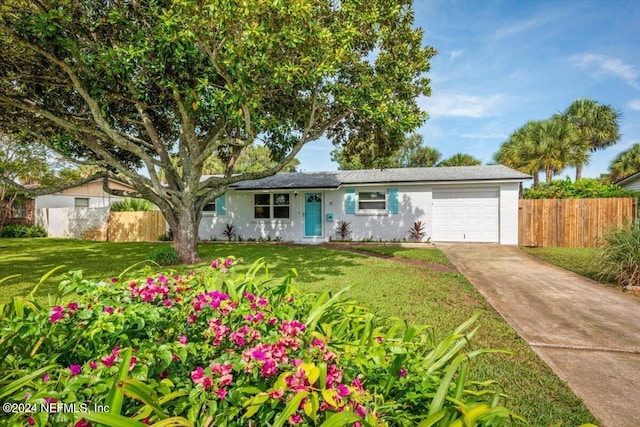 ranch-style home featuring a garage and a front lawn