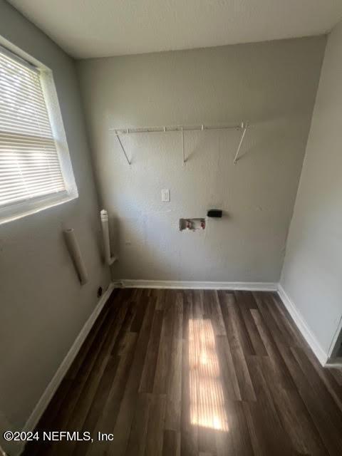 laundry room featuring laundry area, baseboards, and dark wood-style flooring