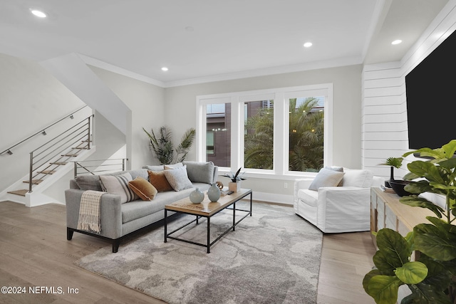 living room featuring crown molding and hardwood / wood-style floors