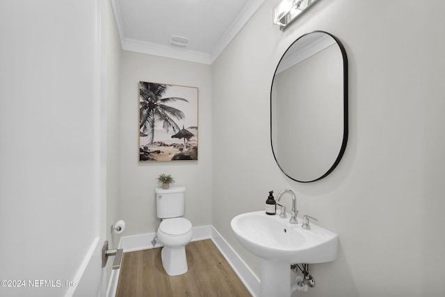 bathroom featuring sink, toilet, ornamental molding, and hardwood / wood-style flooring