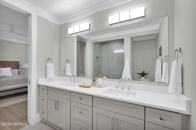 bathroom featuring wood-type flooring, an enclosed shower, vanity, and crown molding